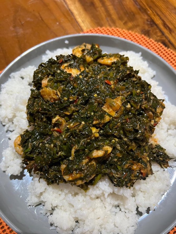 Cassava leaves stew served over white rice