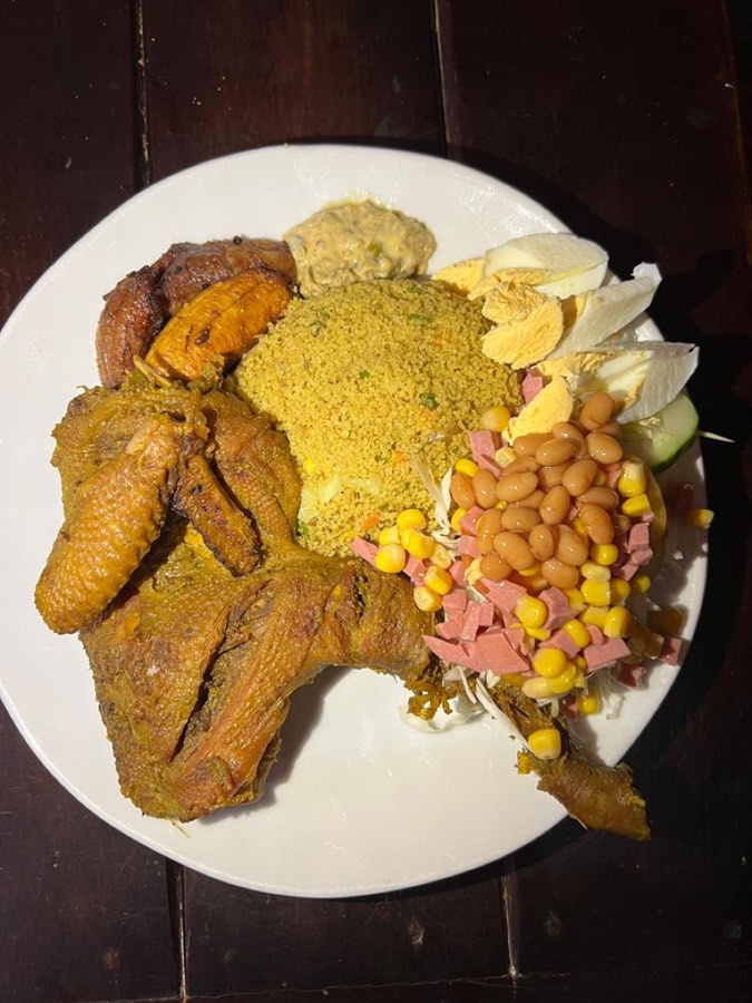 Spicy couscous platter with chicken, plantain and salad