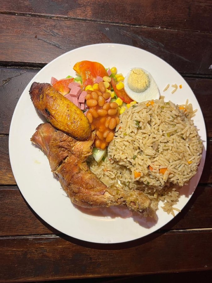 Fried rice with grilled chicken, plantain and salad
