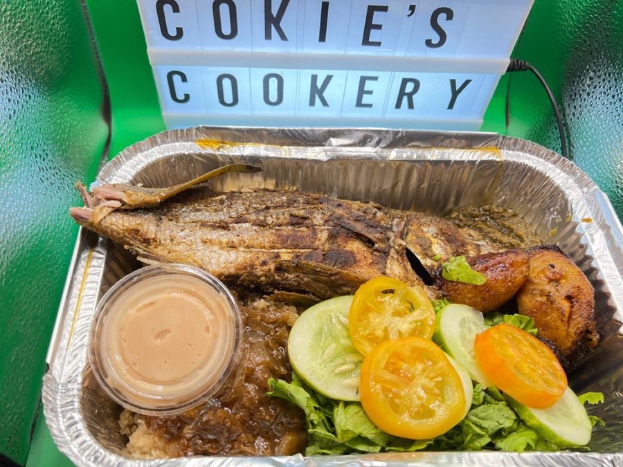 Whole grilled fish with salad and signature sauce