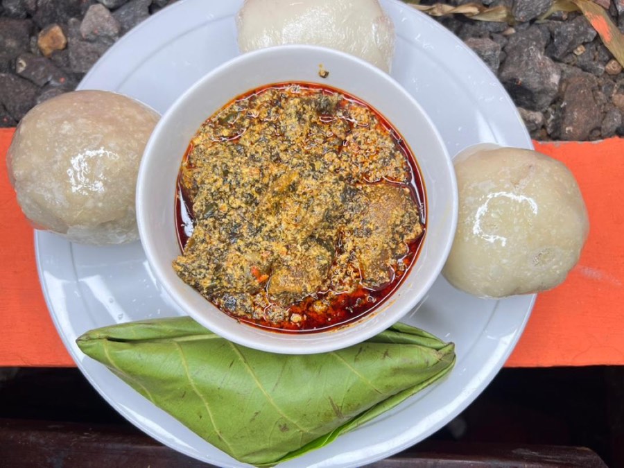 Groundnut soup with foofoo balls and leaf-wrapped sides