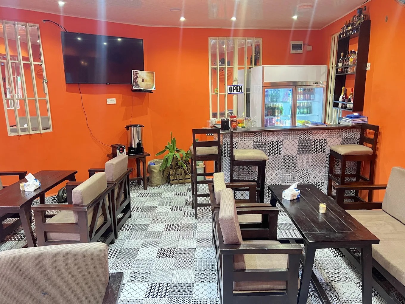 Inside Cokie's Cookery & Bar — orange walls, wooden furniture, and bar area